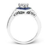 This beautiful pear-shaped setting displays .82 ctw of baguette sapphires in a halo around the center stone. The rest of the ring sparkles with .11 ctw of round diamonds and .17 ctw of baguette diamonds.