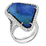 This stunning 18k white gold ring is custom created for the natural boulder opal center stone in its midst. The effect is completed with 1.35 ctw of white diamonds in a halo design.