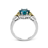 This two-toned vintage inspired right hand ring features a blue zircon center 3.11 ctw. surrounded by white diamonds 0.25 ctw and accented by natural yellow diamonds set in a yellow gold filigree detail.