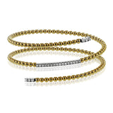 This delicate two-tone gold bangle hugs the wrist with its understated .42 ctw of white diamond accents. Perfect for stacking.