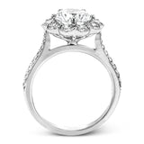 This white gold wedding set frames its centerpiece with .90 ctw of round white diamonds in a whimsical floral-inspired design.
