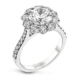 This white gold wedding set frames its centerpiece with .90 ctw of round white diamonds in a whimsical floral-inspired design.
