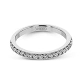 This white gold wedding set frames its centerpiece with .90 ctw of round white diamonds in a whimsical floral-inspired design.