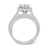 This white gold wedding set frames its centerpiece with .90 ctw of round white diamonds in a whimsical floral-inspired design.