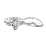 This lovely contemporary design features white gold and .14 ctw of round white diamonds and .42 ctw of oval shaped white diamonds as well as delicate milgrain edging around its centerpiece.