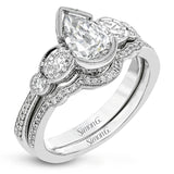 This lovely contemporary design features white gold and .14 ctw of round white diamonds and .42 ctw of oval shaped white diamonds as well as delicate milgrain edging around its centerpiece.