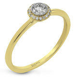 This exquisite, minimalist yellow gold ring features a halo containing .04 ctw of round white diamonds encircling a .16 ctw round white diamond centerpiece