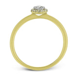 This exquisite, minimalist yellow gold ring features a halo containing .04 ctw of round white diamonds encircling a .16 ctw round white diamond centerpiece