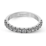 This wedding band has a beautiful timeless design which will be in style for years. The ring contains .77 ctw of white diamonds.