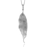 This pendant appears like a realistic leaf cast in gold that sparkles with two dew drops of bezel set diamonds totaling .08 ctw.