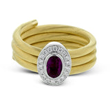 This unique right hand ring of gold coils wraps your finger in luxury and features an oval Ruby 0.57 ctw. surrounded by a halo of wite diamonds 0.14 ctw.