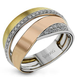 Beautiful and distinctive, this ring features overlapping bands in three-tone gold, with .20 ctw of round white diamonds shimmering from the white gold sections