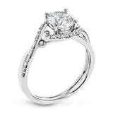 This nature inspired 18K engagement ring has a simple twist design with a combination of high polish gold band and .20 ctw RD diamonds leading up to the center