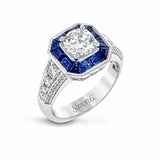 This stunning bridal ring design has a unique geometric halo set with 1.03 ctw of beautiful blue sapphires. The rest of the ring contains .52 ctw of white diamonds.