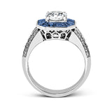 This stunning bridal ring design has a unique geometric halo set with 1.03 ctw of beautiful blue sapphires. The rest of the ring contains .52 ctw of white diamonds.