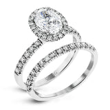 This is a classic halo design wedding set made for an oval center stone contains .72 ctw of white diamonds.