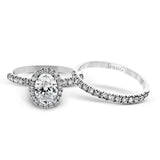 This is a classic halo design wedding set made for an oval center stone contains .72 ctw of white diamonds.