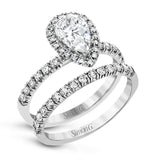 This white gold wedding set is simple yet dazzling with .71 ctw of round white diamonds framing an eye-catching pear shaped centerpiece.