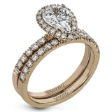 This white gold wedding set is simple yet dazzling with .71 ctw of round white diamonds framing an eye-catching pear shaped centerpiece.