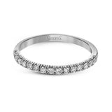This white gold wedding set is simple yet dazzling with .71 ctw of round white diamonds framing an eye-catching pear shaped centerpiece.