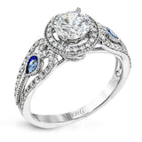 This intricate vintage-inspired engagement ring has two accent sapphire side stone totaling .25 ctw, while .33 ctw of white diamonds sparkle on the rest of the setting.