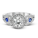 This intricate vintage-inspired engagement ring has two accent sapphire side stone totaling .25 ctw, while .33 ctw of white diamonds sparkle on the rest of the setting.