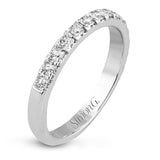 This beautiful white gold engagement ring is set with .55 ctw of round white diamonds flanking the center stone, as well as a distinctive rose gold accent