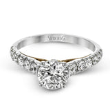 This beautiful white gold engagement ring is set with .55 ctw of round white diamonds flanking the center stone, as well as a distinctive rose gold accent