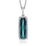 This sleek, vintage-inspired white gold pendant features .22 ctw of white diamonds framing a gorgeous 3.07ctw of green tourmaline