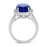 This dazzling vintage-inspired ring in white gold features a gorgeous 7.01 ctw tanzanite framed by 1.16 ctw of round white diamonds in a beautiful halo and split-shank design.