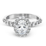 This white gold ring's clean, modern design features a halo and shank that dazzle with .70 ctw of round white diamonds.