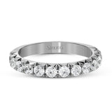 This band pairs perfectly with an engagement ring, or can be worn on its own or stacked with other rings. It contains .75 ctw of white diamonds.