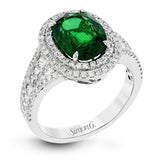 This beautiful white gold ring dazzles with its 2.56 ctw oval shaped emerald centerpiece, flanked by .50 ctw of round white diamonds and .45 ctw of princess cut white diamonds.