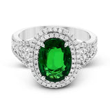 This beautiful white gold ring dazzles with its 2.56 ctw oval shaped emerald centerpiece, flanked by .50 ctw of round white diamonds and .45 ctw of princess cut white diamonds.