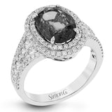 This beautiful white gold ring dazzles with its 2.56 ctw oval shaped emerald centerpiece, flanked by .50 ctw of round white diamonds and .45 ctw of princess cut white diamonds.
