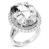 Opulent and glamorous, this white and rose gold ring features a jaw-dropping 28.60 ctw oval shaped tanzanite ringed by a double halo and a total of 1.80 ctw of round white diamond accents.