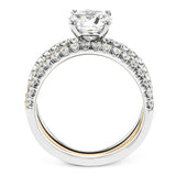 This distinctive bridal set design features a double-layer wedding band that fits around the engagement ring. The set contains .77 ctw of white diamonds.