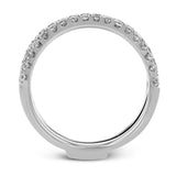 This distinctive bridal set design features a double-layer wedding band that fits around the engagement ring. The set contains .77 ctw of white diamonds.
