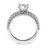 This distinctive bridal set design features a double-layer wedding band that fits around the engagement ring. The set contains .77 ctw of white diamonds.