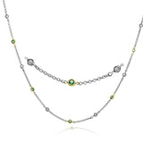 Set with 1.18 ctw of white diamonds and 1.32 ctw of lovely green emeralds, this modern necklace adds the perfect touch of color and sparkle to any outfit.