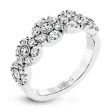 This whimsical white gold ring features .78 ctw of round white diamonds accentuated by .07 ctw of round pink diamonds as well as rose gold details in a playful floral design.