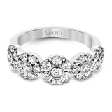 This whimsical white gold ring features .78 ctw of round white diamonds accentuated by .07 ctw of round pink diamonds as well as rose gold details in a playful floral design.