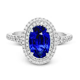 This gorgeous, vintage-inspired white gold ring features a 2.98 ctw oval shaped sapphire framed by a double halo and .42 ctw of round white diamond accents.