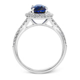This gorgeous, vintage-inspired white gold ring features a 2.98 ctw oval shaped sapphire framed by a double halo and .42 ctw of round white diamond accents.