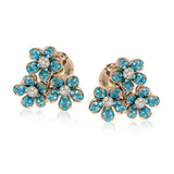 These charming 18k white gold stud earrings feature a grouping of five-petaled flowers made from 1.09 ctw of bright, saturated blue paraiba tourmaline and .17 ctw of white diamonds.
