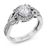 This amazing 18k white gold engagement ring features vintage-inspired design elements set with .28 ctw of white diamonds.