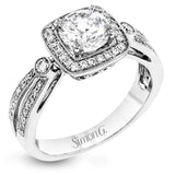 This wonderful 18k white gold ring has a distinctive design with a soft square halo and .34 ctw of white diamonds.