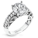 This 18k white gold engagement ring has a design taken from nature with leaves and filigree set with .43 ctw of white diamonds.