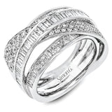Bold and modern, this 18k white gold ring contains 1.11 ctw of baguette diamonds and .48 ctw of round diamonds set into a dynamic, overlapping design.