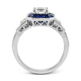 This 18k white gold engagement setting would be a perfect 'something blue' with .79 ctw of baguette sapphires in a halo surrounding the center stone. These are framed by .33 ctw of princess cut diamonds and .11 ctw of round brilliant diamonds.